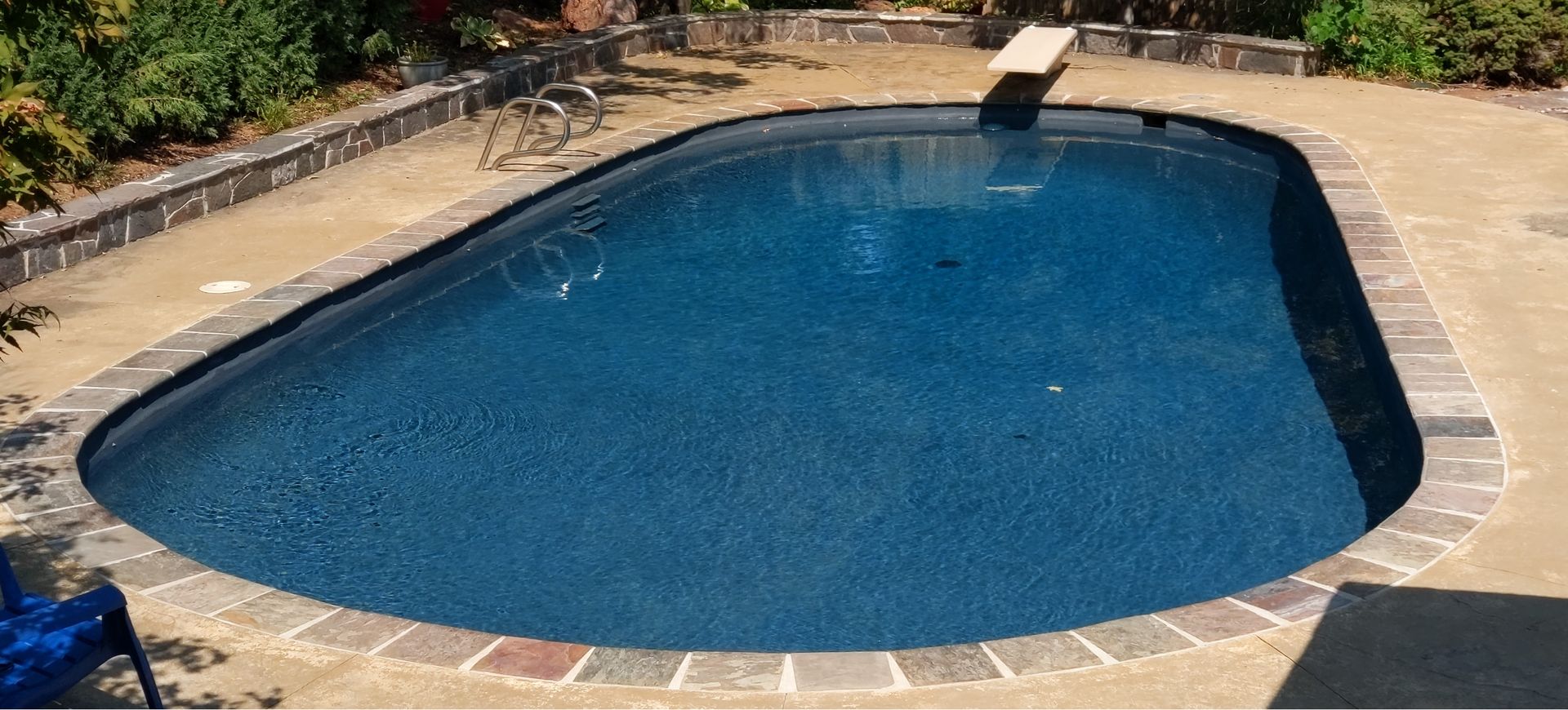 Clear, turquoise water surface with sunlight creating shimmering patterns.