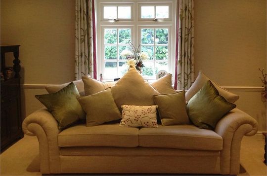 sofa with five cushions in small sitting room