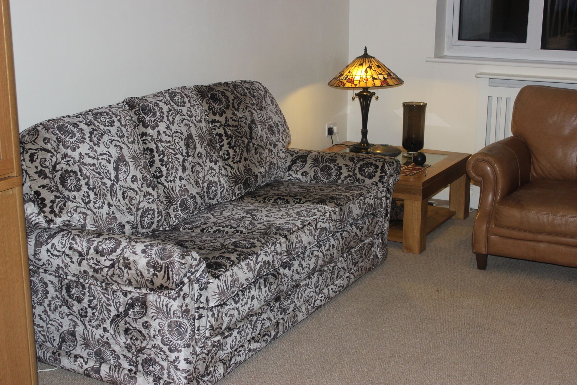 sofa upholstered in grey floral pattern