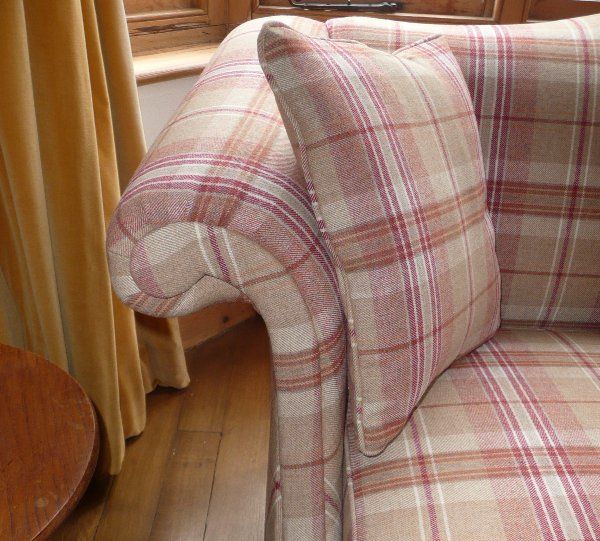 detail of armchair upholstered in pink and cream tartan