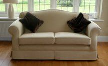 two seater sofa in coffee with two dark brown cushions
