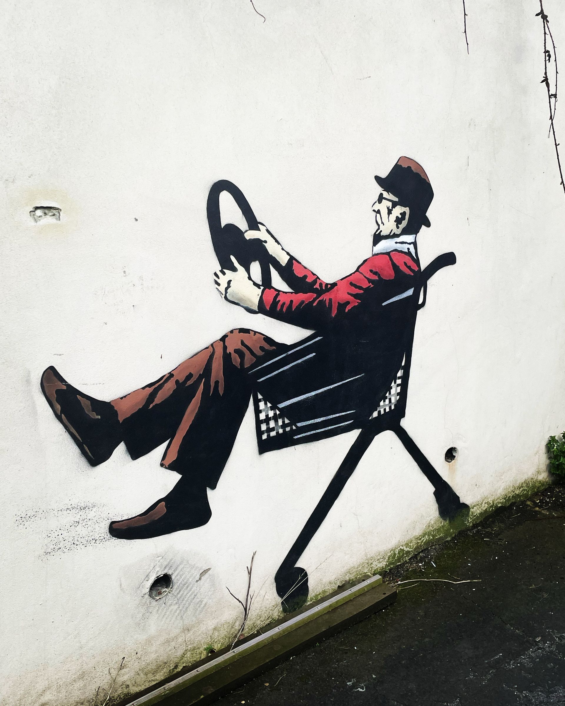A mural of a man in a shopping trolley.