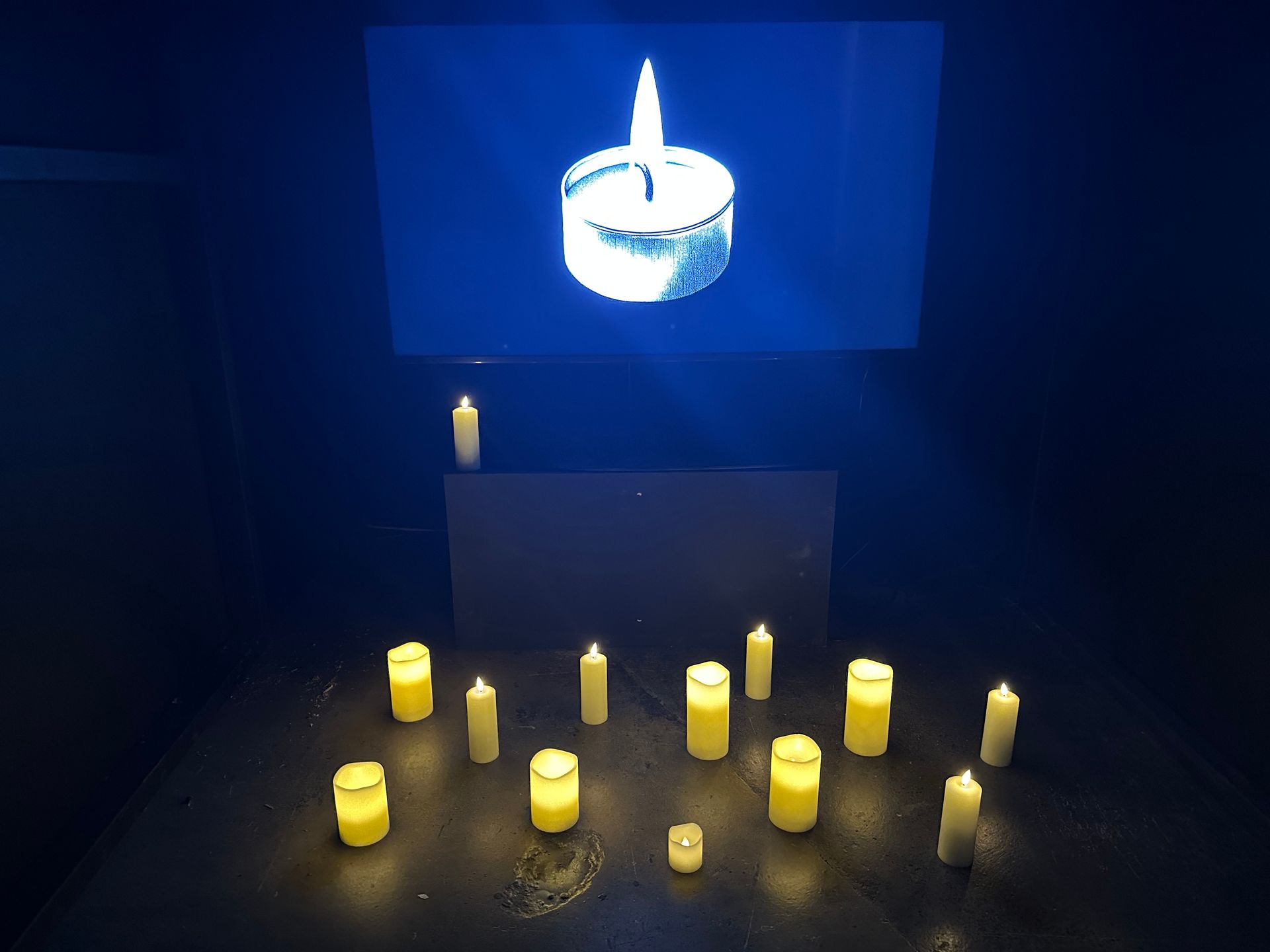 Candle on a screen with LED candles below