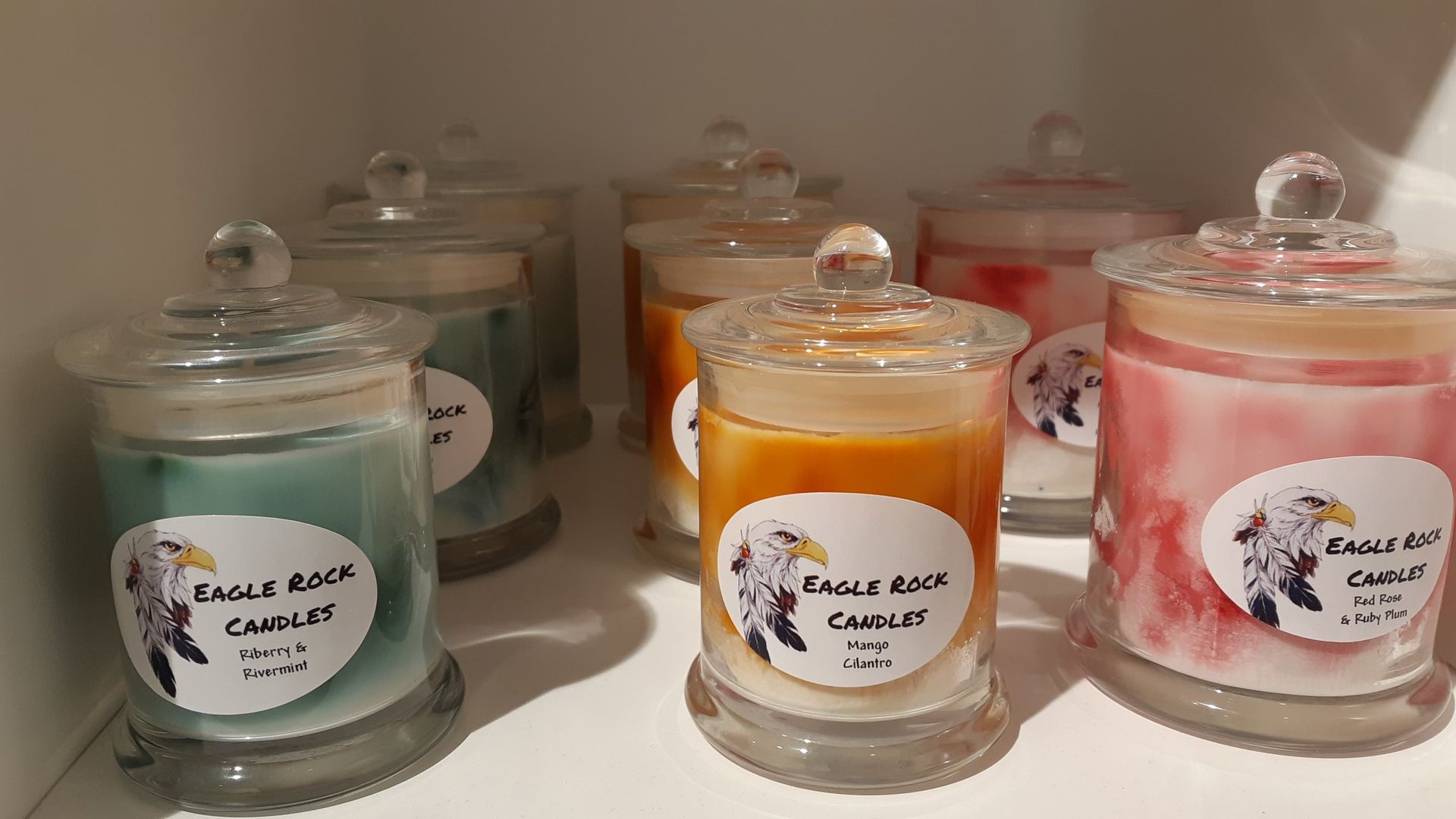 A Row of Candles in Glass Jars with Lids on A Shelf — Eagle Rock Candles in Wodonga, VIC