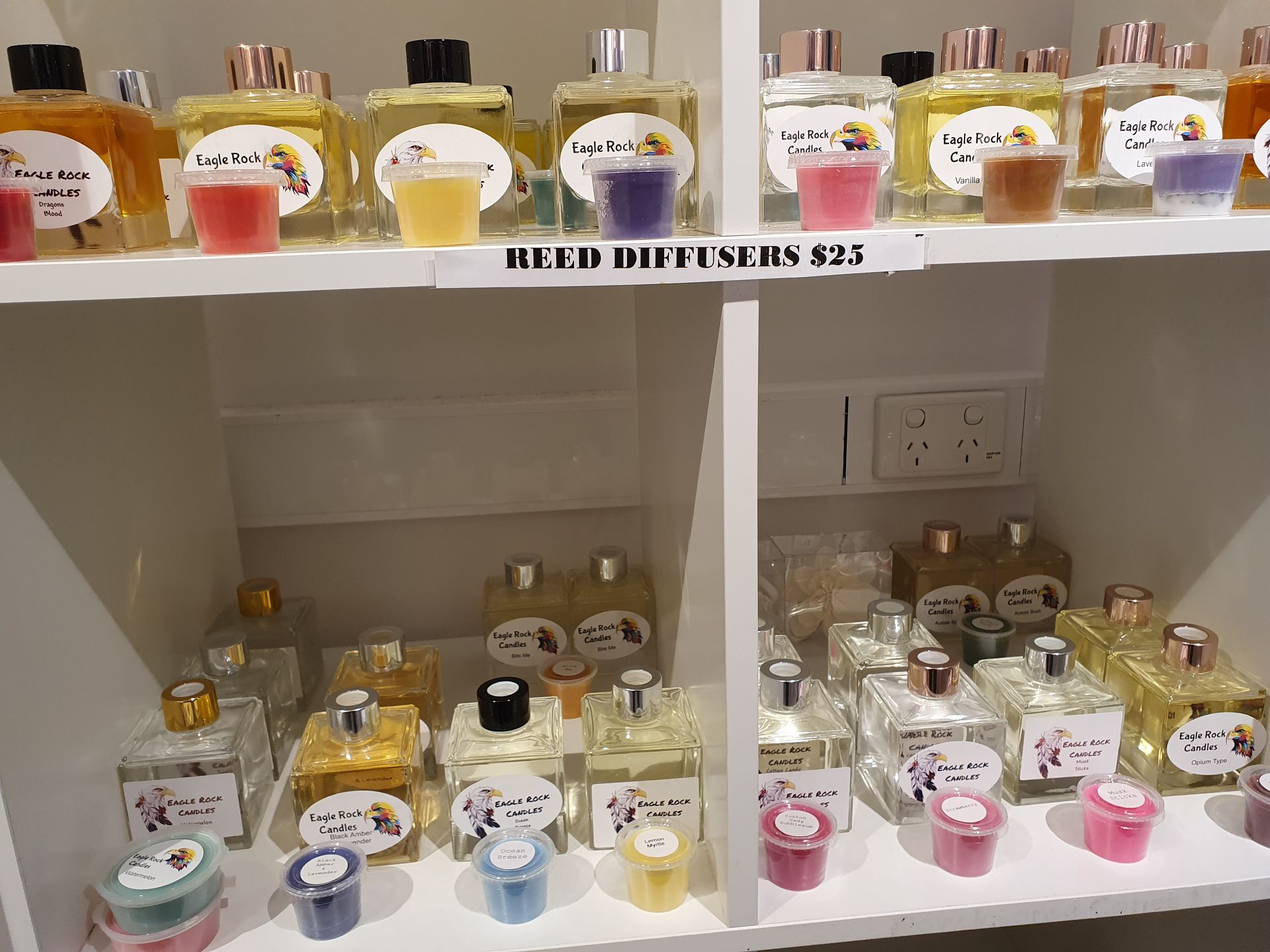 A Shelf Filled with Bottles of Perfume and Candles — Eagle Rock Candles in Wodonga, VIC