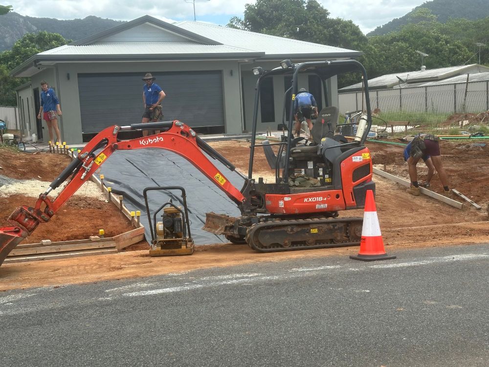 A Bulldozer And An Excavator Are Working On A Construction Site — Glen Tier Bobcat & Truck Hire In Woree, QLD
