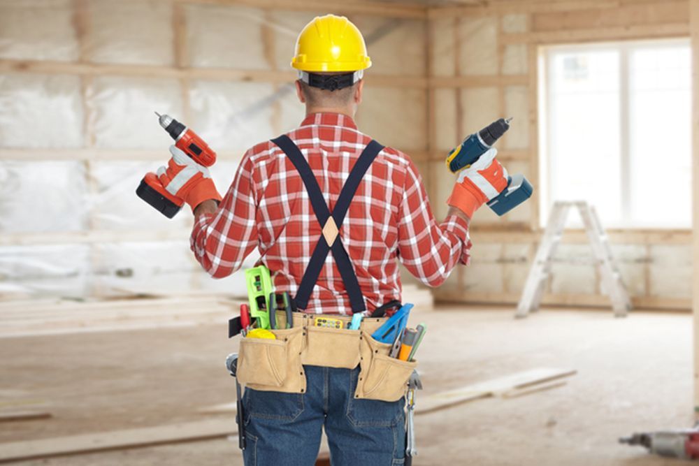 Man Holding 2 Drillers While Facing at the Back — Builder in Seventeen Seventy, QLD