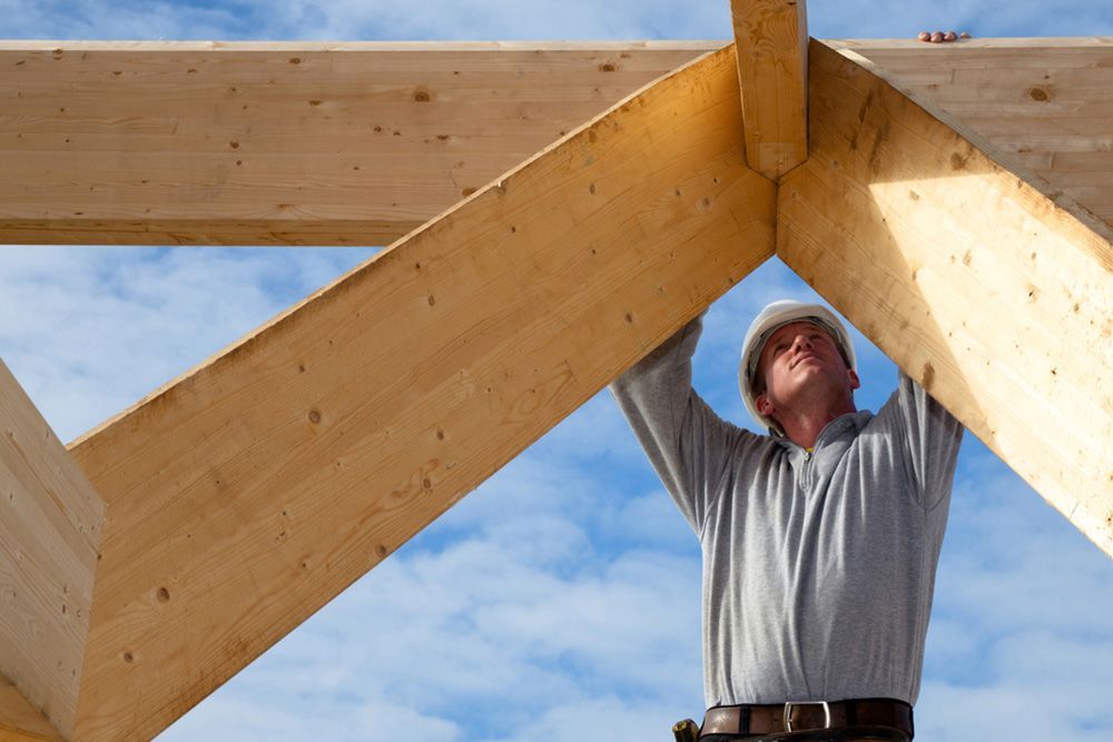 Man Checking the Structure of the Roof — Builder in Lowmead, QLD