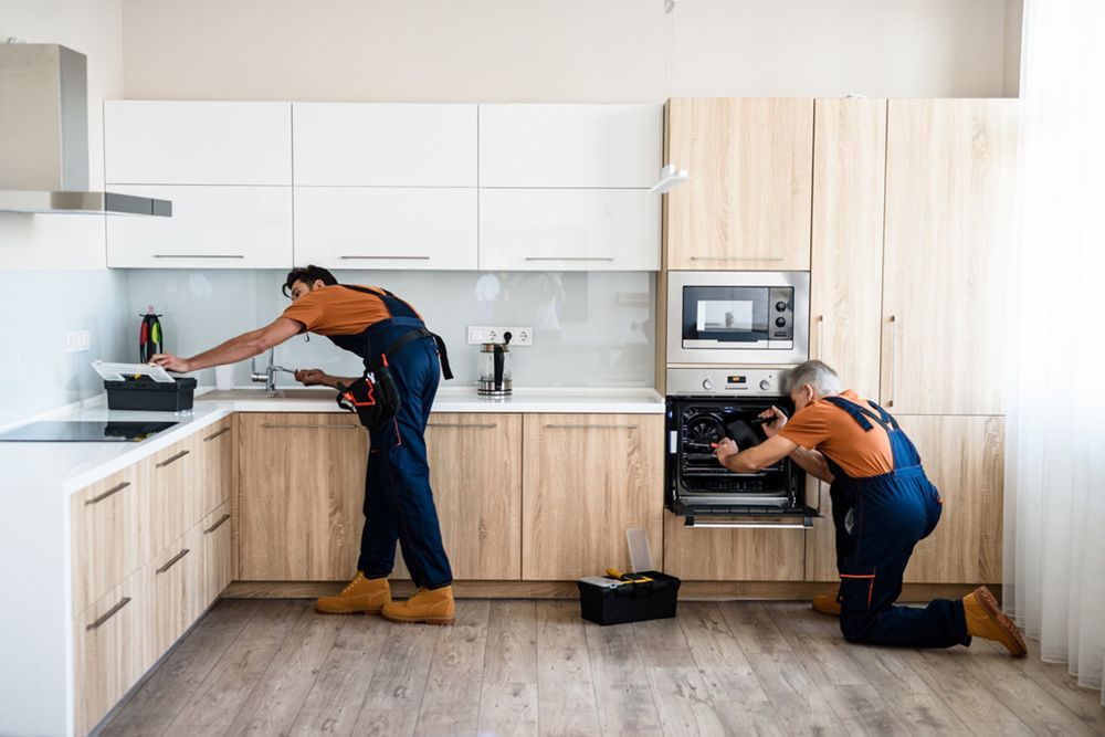 2 Worker Finishing Up the Renovation of the Kitchen — Kitchen Renovation in Gladstone Region, QLD