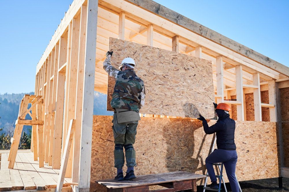 2 Man Placing a Plywood for the House Walls — Builder in Seventeen Seventy, QLD