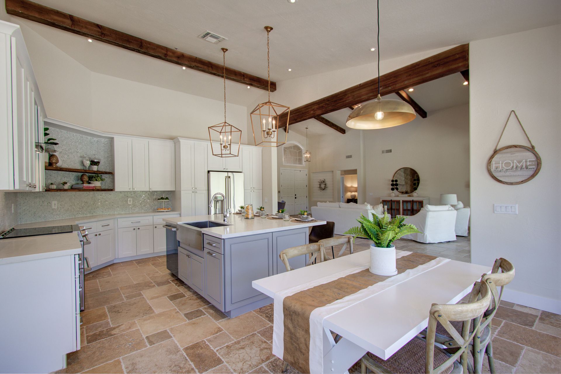 A kitchen and dining room in a house with a table and chairs.