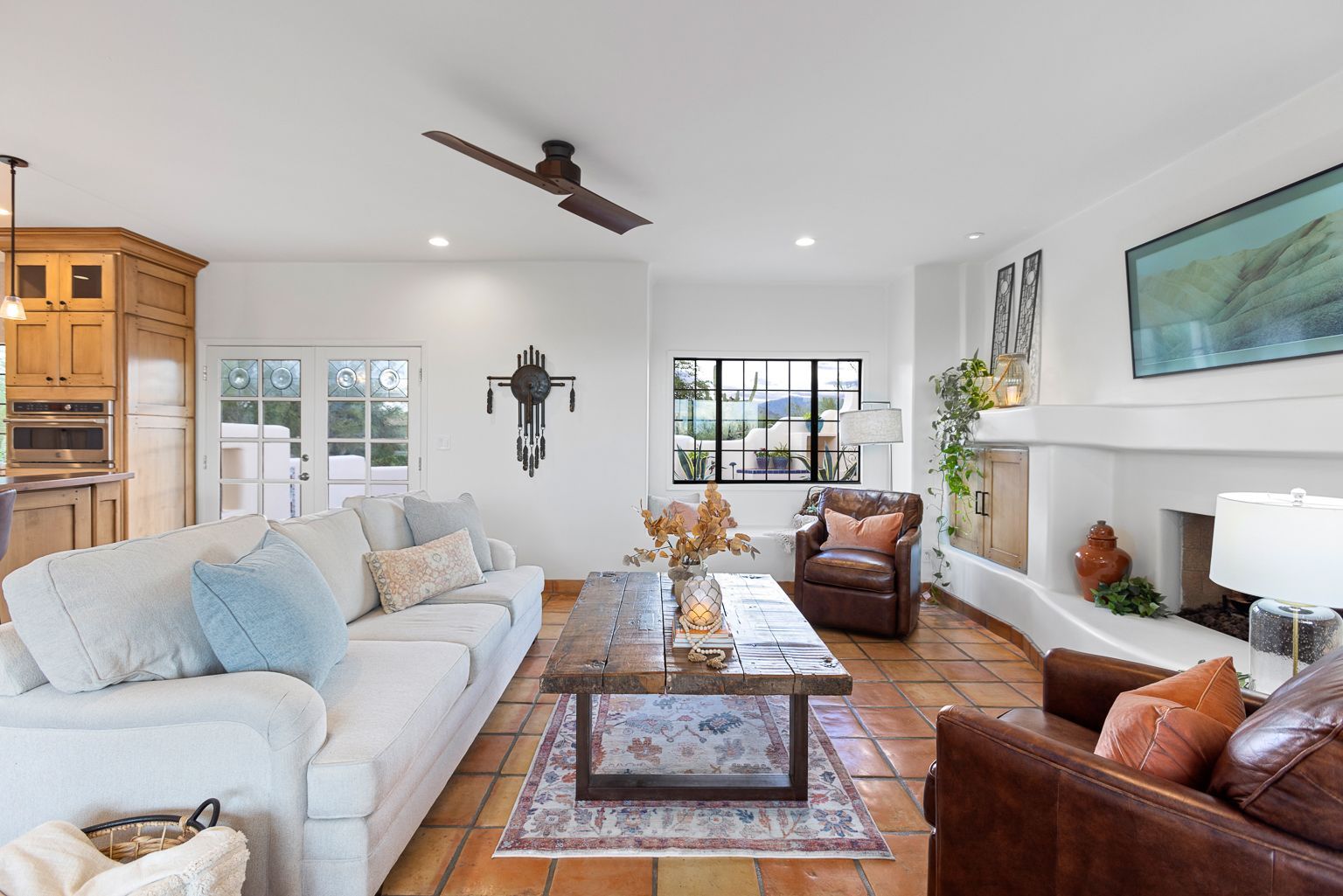 A living room filled with furniture and a ceiling fan.