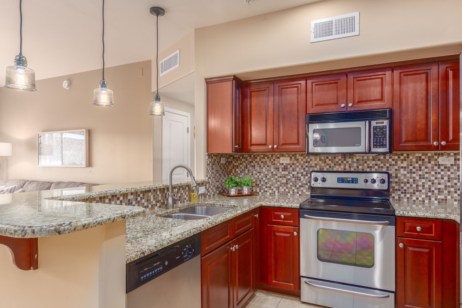 A kitchen with stainless steel appliances and wooden cabinets.