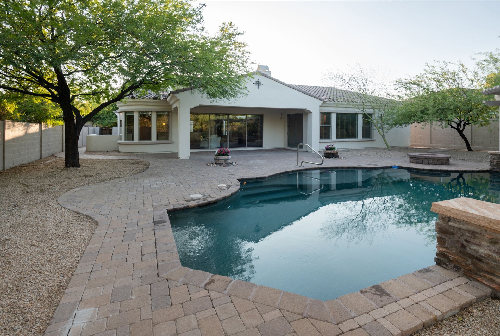 A large swimming pool in the backyard of a house
