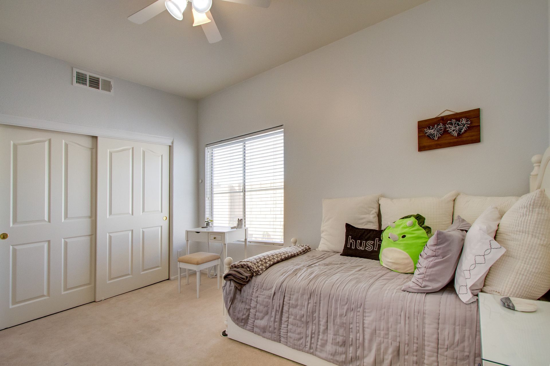 A bedroom with a day bed and a ceiling fan.
