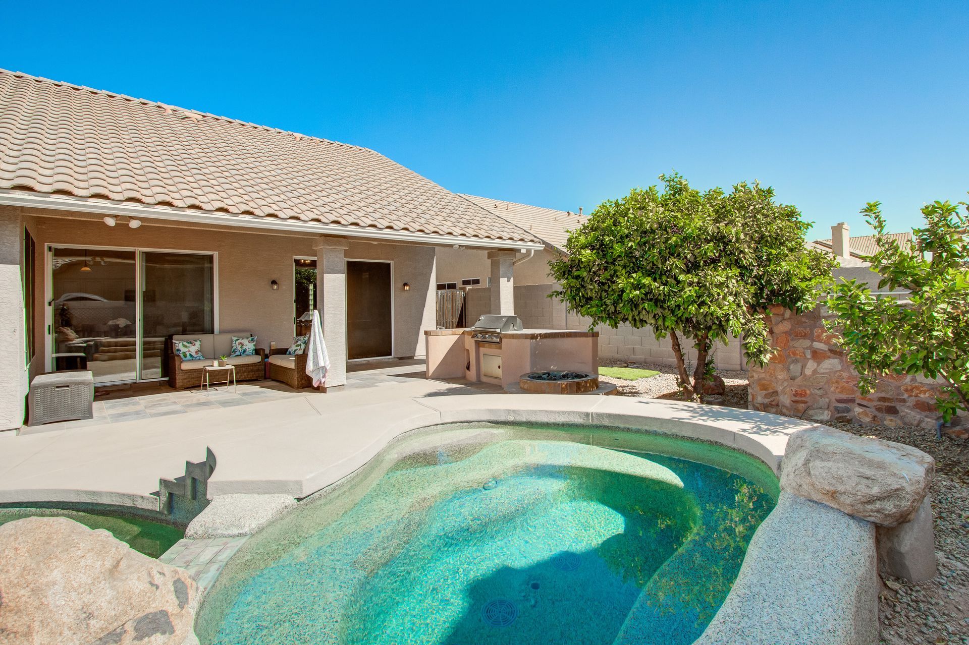 A house with a large swimming pool in front of it