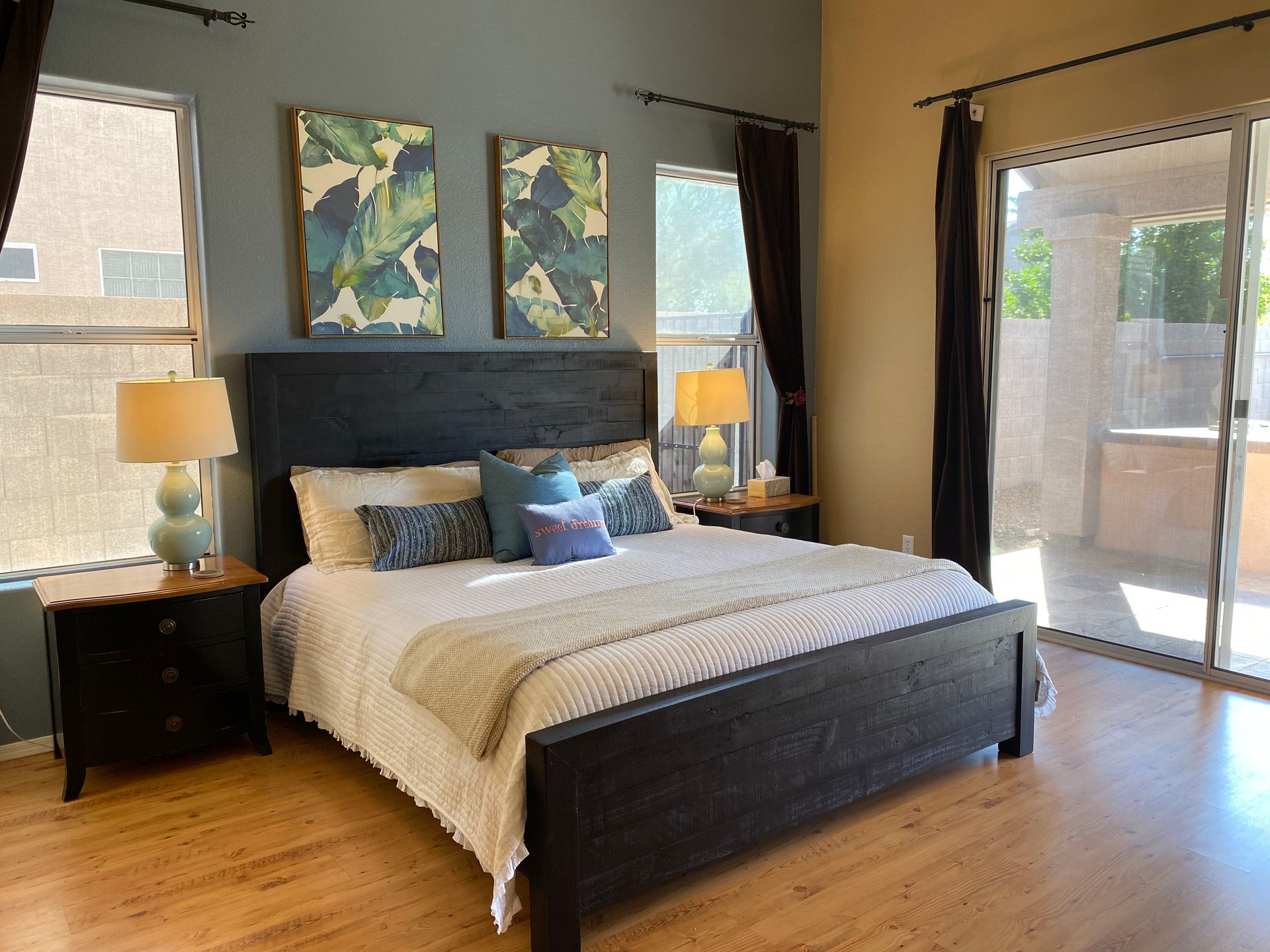 A bedroom with a king size bed and a sliding glass door