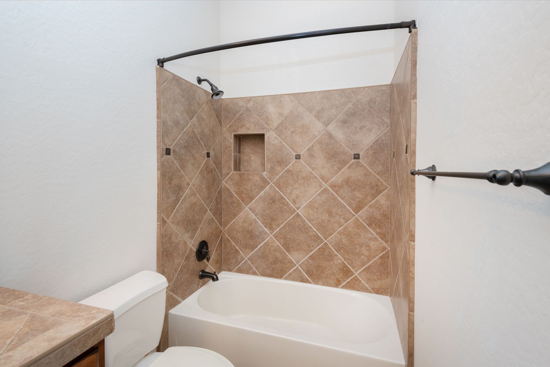 A bathroom with a toilet , bathtub and shower.