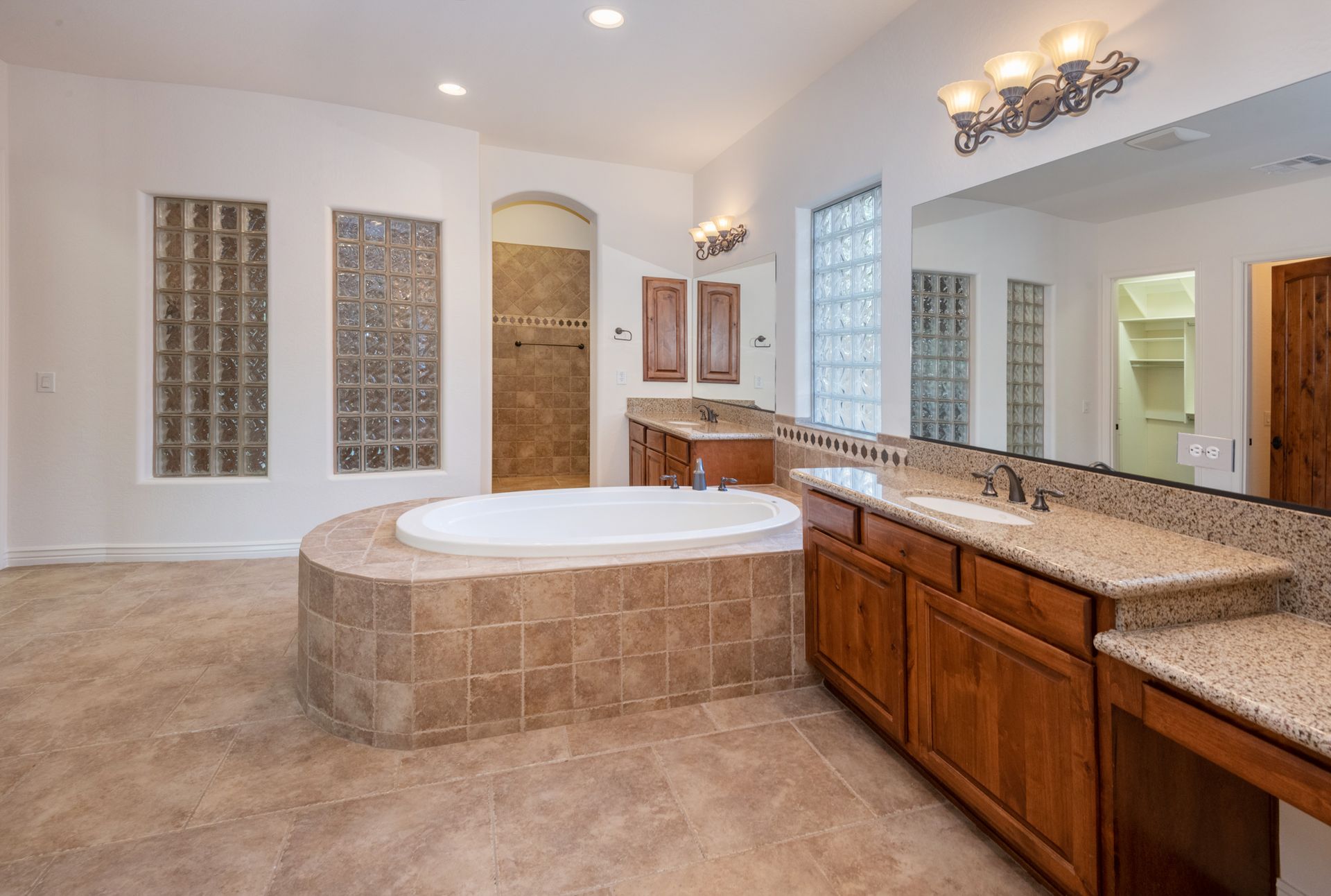 A bathroom with a tub , sink , and mirror.