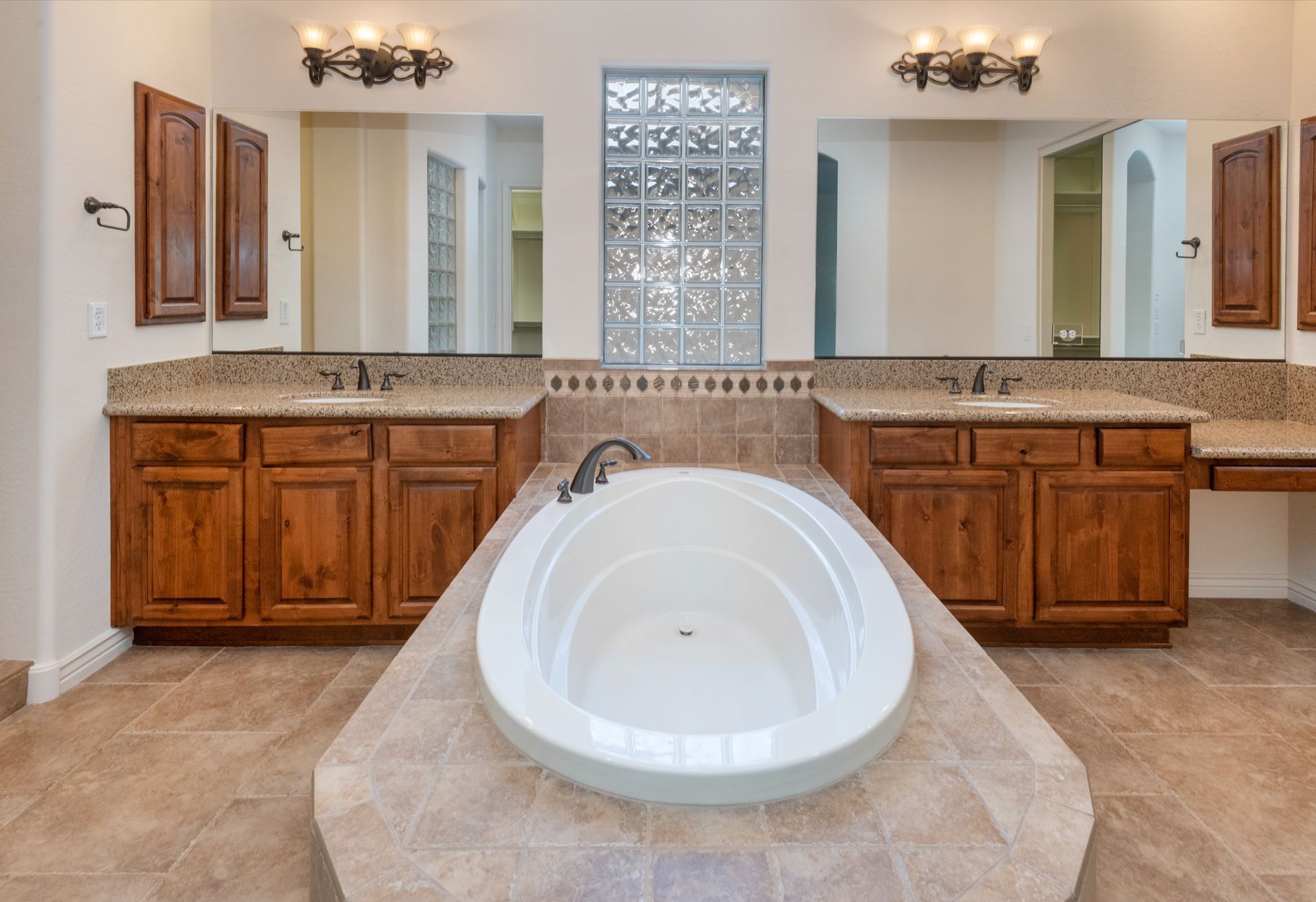 There is a large bathtub in the middle of the bathroom.