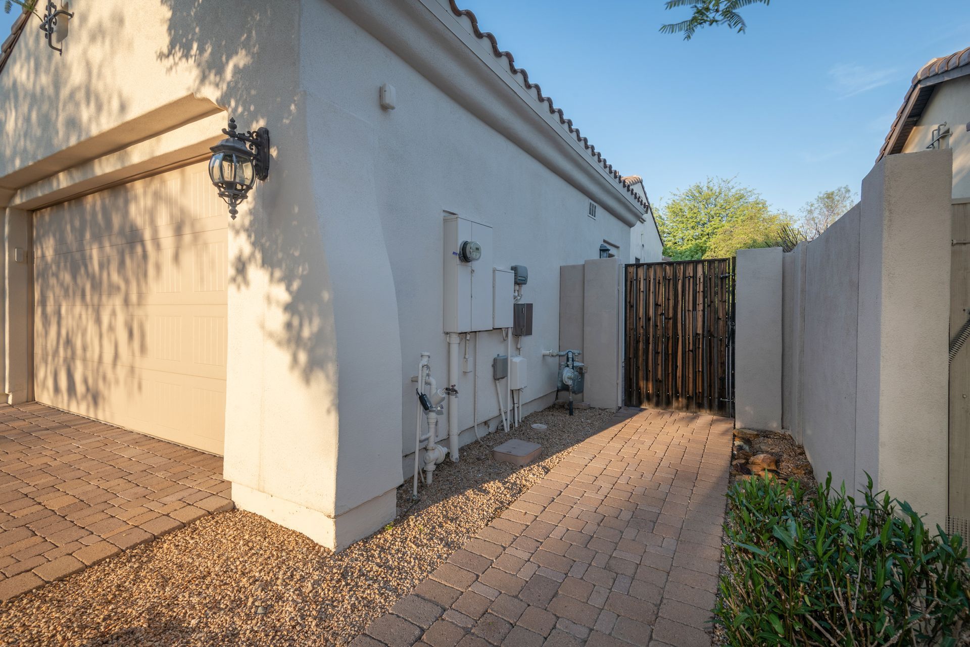 A white house with a brick walkway leading to it.
