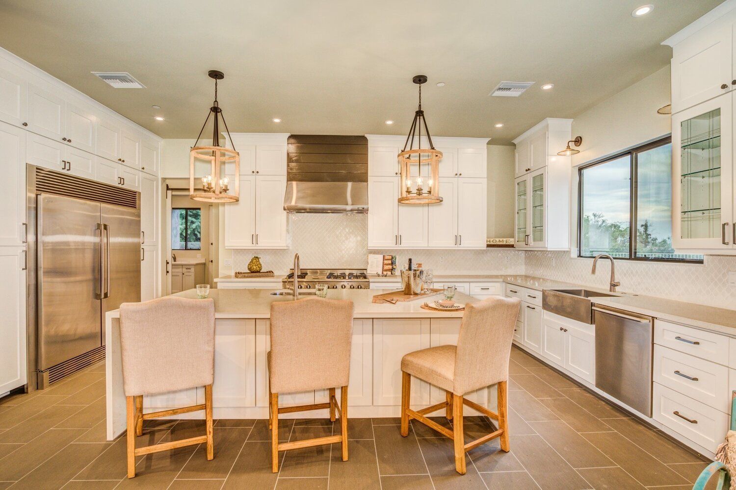 A kitchen with white cabinets and stainless steel appliances