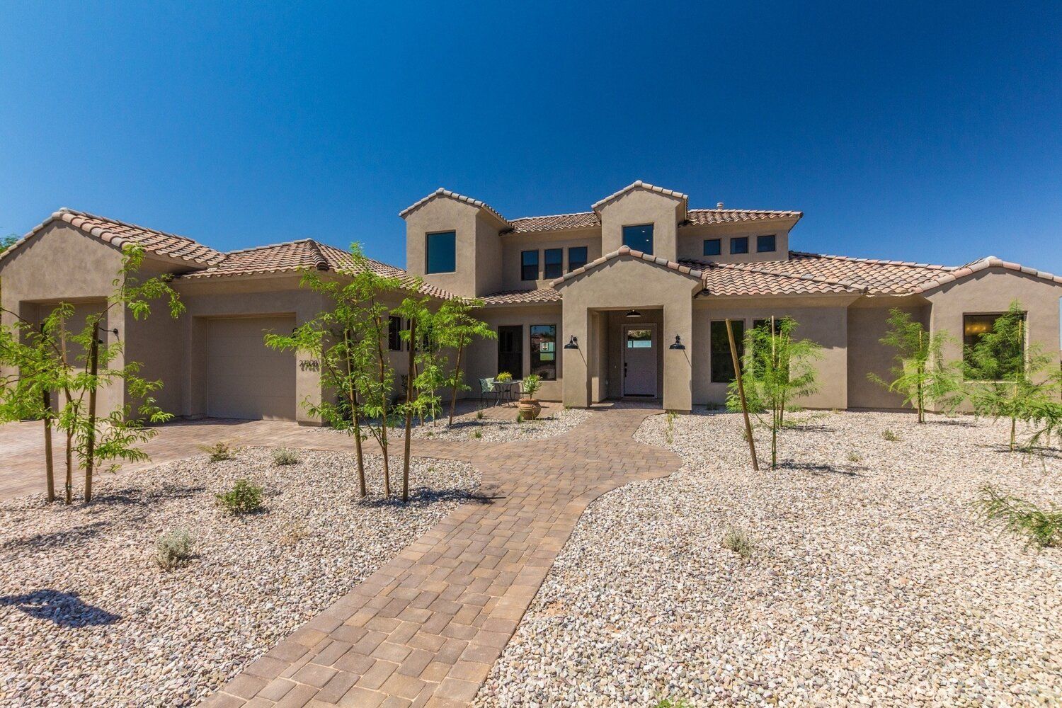 A large house with a brick walkway leading to it