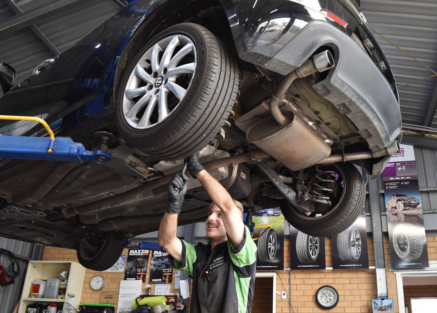 mechanic+fixing+car+suspension