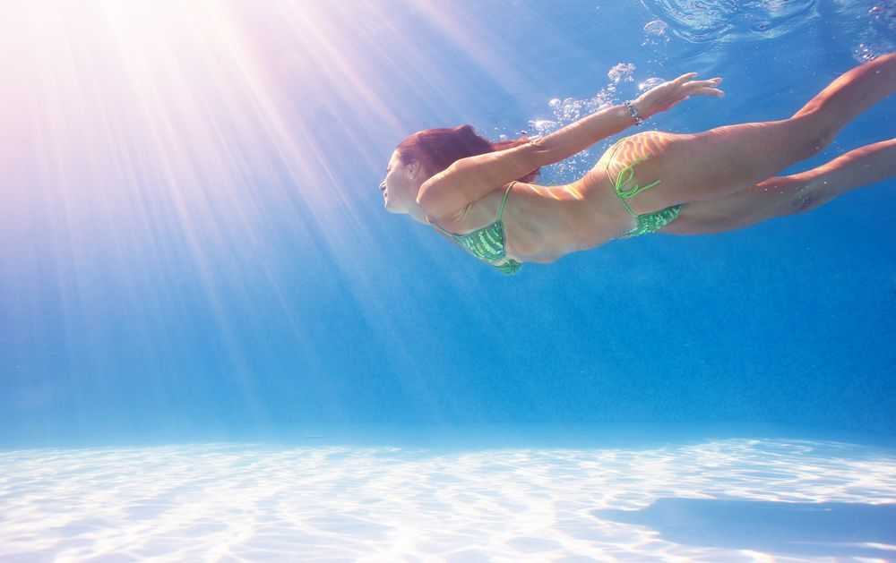 A Woman in a Bikini is Swimming Underwater in a Pool — Fannie Bay Pool Shop in Winnellie, NT