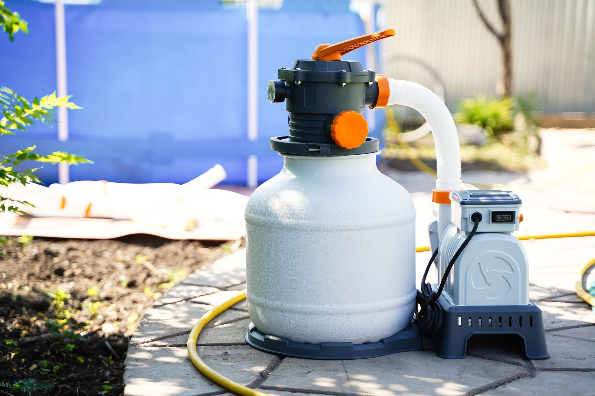 Sand Filter Pool Pump Next to a Blue Above-ground Pool — Fannie Bay Pool Shop in Northern Suburbs, NT