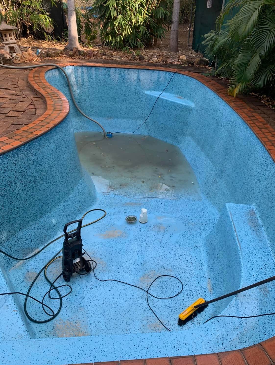 Empty Blue-tiled Pool With Sediment, Pump, and Hose — Fannie Bay Pool Shop in Palmerston, NT