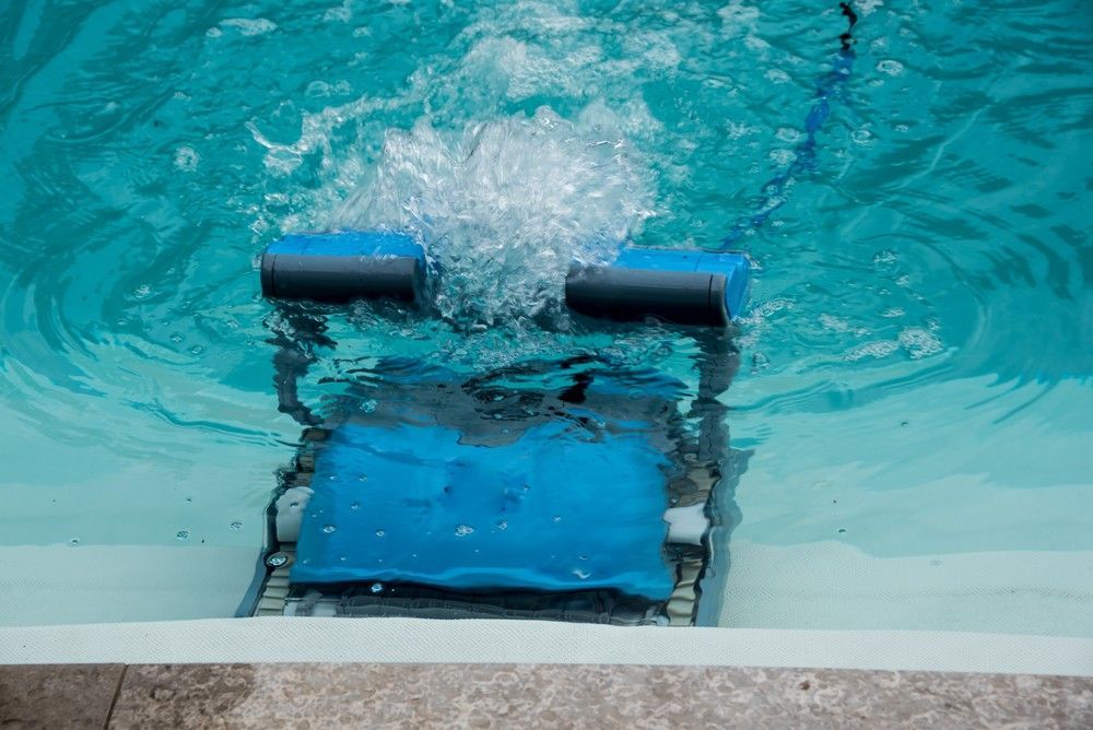 A Robotic Pool Cleaner is Cleaning a Swimming Pool — Fannie Bay Pool Shop in The Narrows, NT