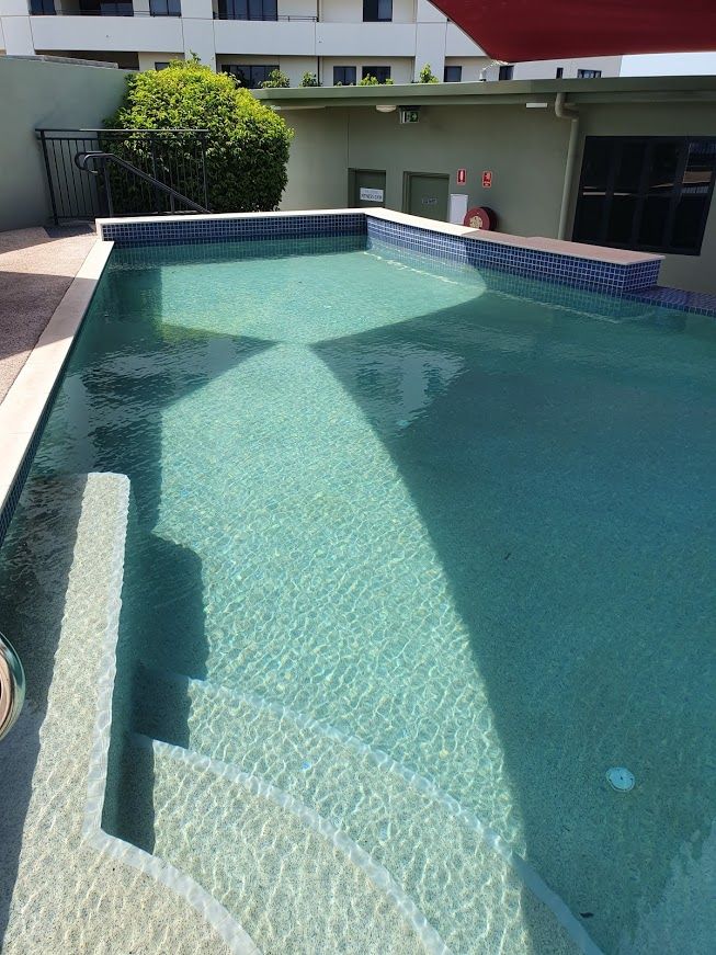 A Large Swimming Pool With Stairs Leading Up to It — Fannie Bay Pool Shop in Winnellie, NT