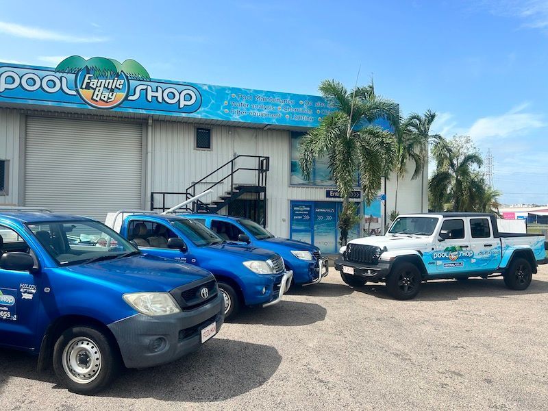 A Row of Blue Trucks Are Parked in Front of a Pool Shop — Fannie Bay Pool Shop in Winnellie, NT
