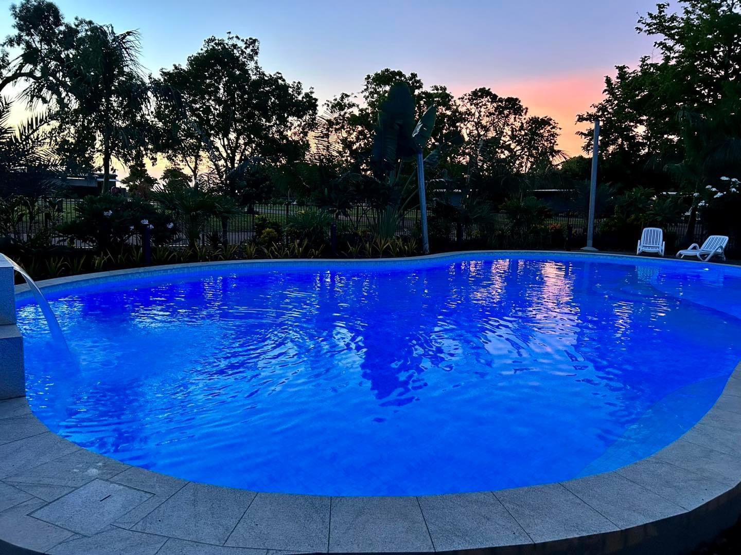A Large Swimming Pool With a Sunset in the Background — Fannie Bay Pool Shop in Winnellie, NT