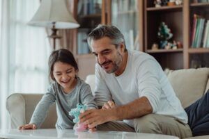 dad and child play with toys in comfortable home