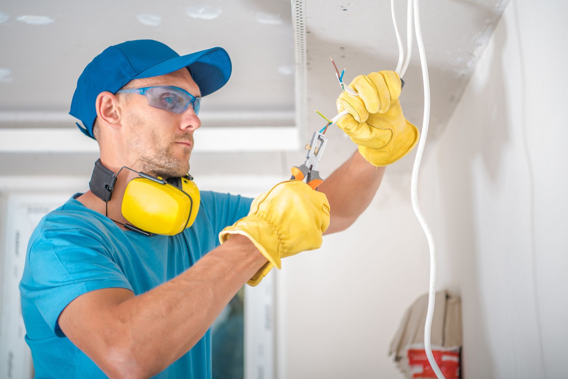 A man is working on a light fixture in a room.
