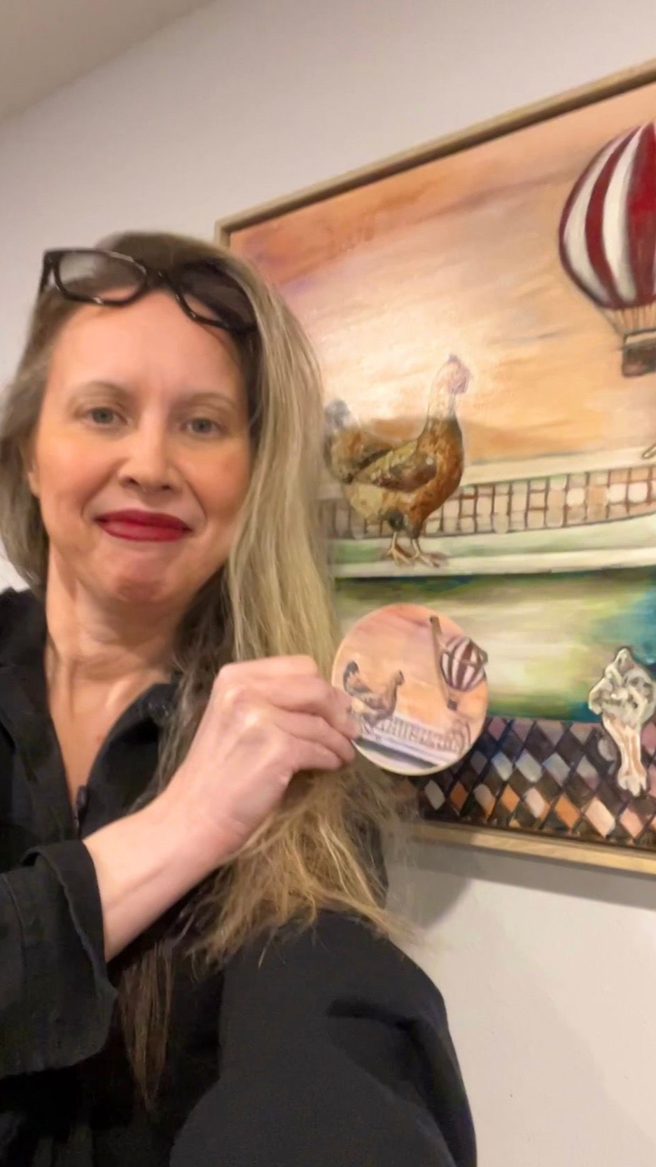 A woman is holding a child in front of a large ship