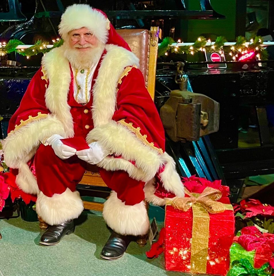 A man dressed as santa claus is sitting on a chair