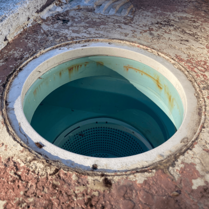 A manhole cover with a hole in the middle of it