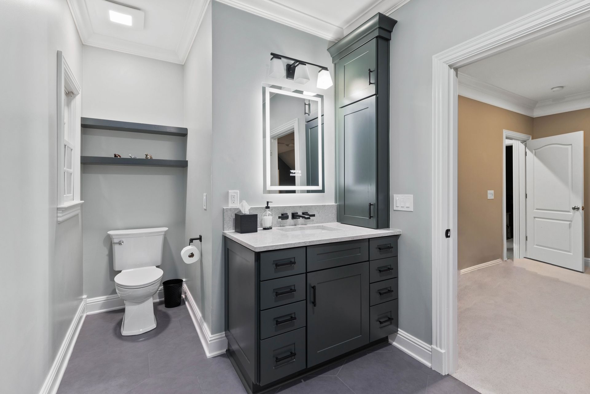 A bathroom with a toilet , sink and mirror.