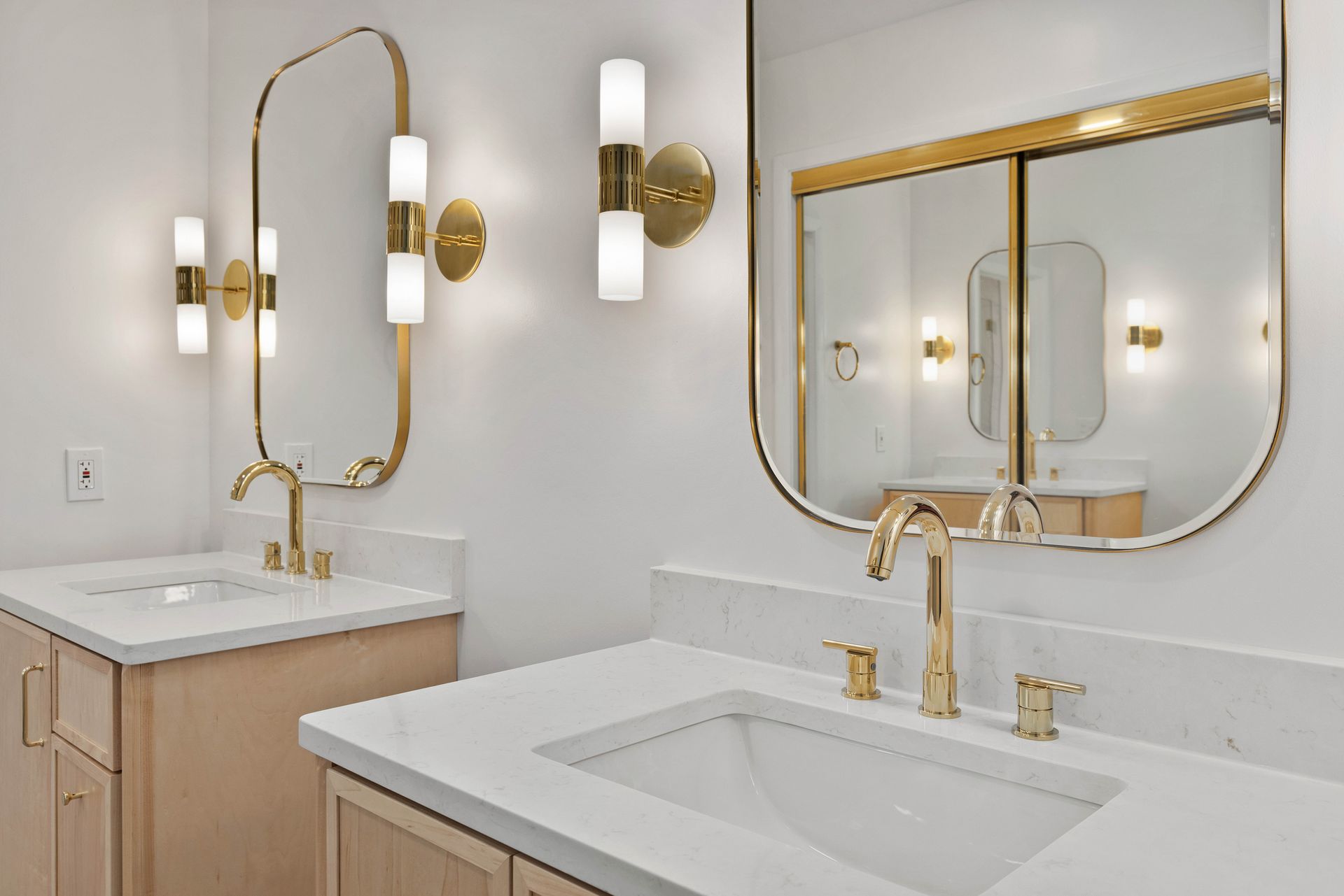 A bathroom with two sinks and two mirrors.