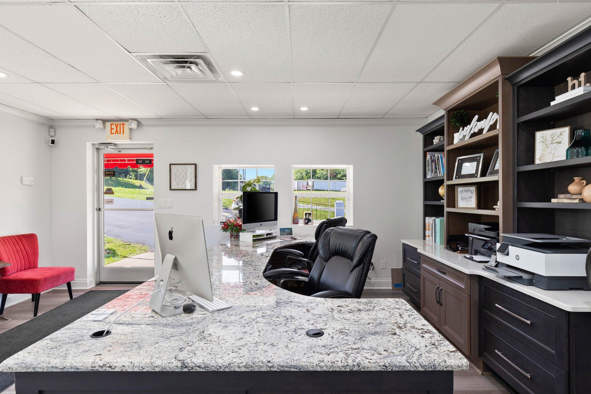 An office with a large desk and a computer on it