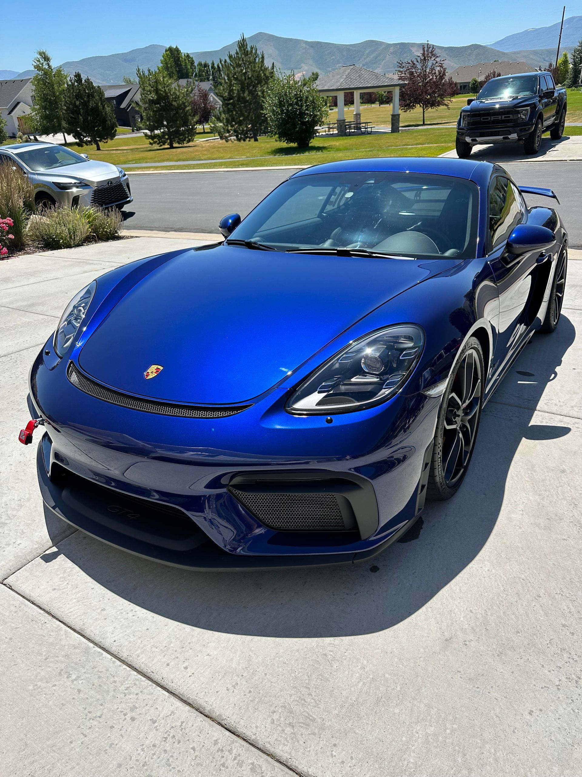 A blue porsche is parked on the side of the road