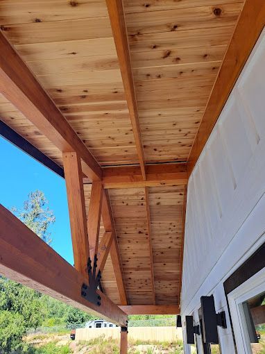 A wooden table with a bowl of pine cones on it