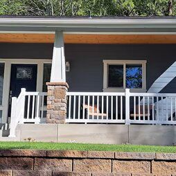A house with a porch and a white railing.