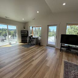 A living room with hardwood floors and a flat screen tv.