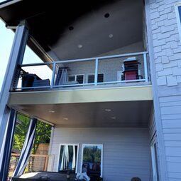 A house with a balcony and a hot tub on it.