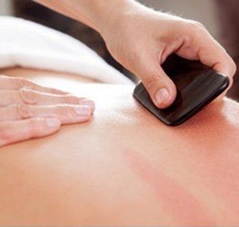 A person is giving a massage to another person.