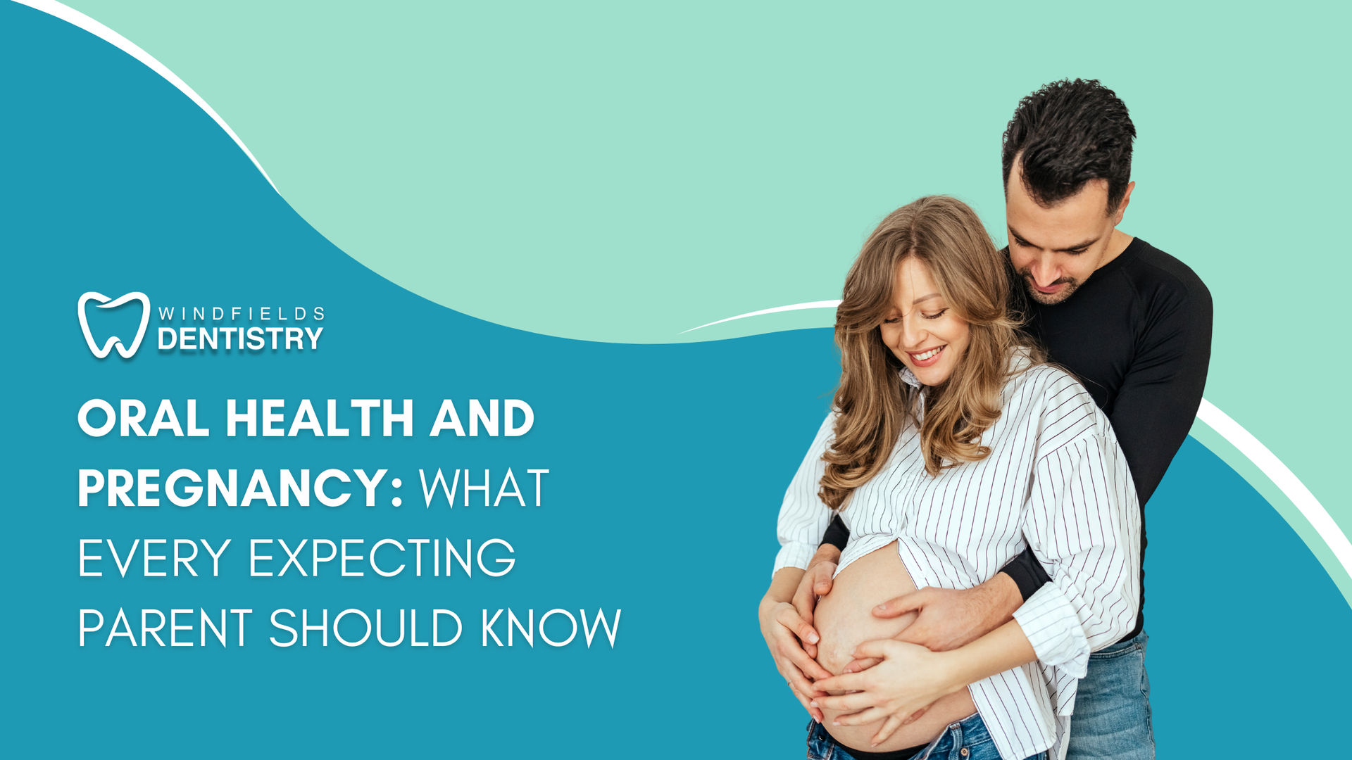 A man is hugging a pregnant woman who is holding her belly.